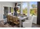 Bright dining room with a rustic wooden table, woven chairs, and expansive backyard views at 9658 Farragut, Indianapolis, IN 46256