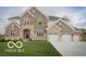Elegant two-story home with stone and brick, featuring a spacious three-car garage at 9658 Farragut, Indianapolis, IN 46256