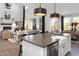 Well-appointed kitchen with modern fixtures and views into the living and dining spaces at 9658 Farragut, Indianapolis, IN 46256