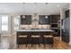 Modern eat-in kitchen featuring an island, bar seating, stainless steel appliances and ample lighting at 9658 Farragut, Indianapolis, IN 46256