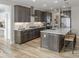 Modern kitchen with island, pendant lights, stainless steel appliances, and ample cabinetry at 9658 Farragut, Indianapolis, IN 46256