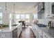 Gourmet kitchen with island seating, stainless appliances, and views into the dining area at 9658 Farragut, Indianapolis, IN 46256