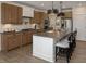 Bright kitchen with large island, breakfast bar, stainless appliances, and wood floors at 9658 Farragut, Indianapolis, IN 46256
