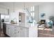 Open-concept kitchen with a large island, stainless steel appliances, and view into the living room at 9658 Farragut, Indianapolis, IN 46256