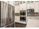 Kitchen with stainless steel appliances, white cabinets, subway tile backsplash, and modern countertops at 9658 Farragut, Indianapolis, IN 46256