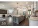 A spacious open-concept kitchen features dark hardwood floors, a center island, and stainless steel appliances at 9658 Farragut, Indianapolis, IN 46256