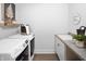 Functional laundry room with washer, dryer, sink and shelving at 9658 Farragut, Indianapolis, IN 46256