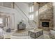Cozy living room with a stone fireplace and staircase, filled with natural light at 9658 Farragut, Indianapolis, IN 46256