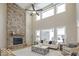 Open living room with a stone fireplace, high ceilings and large windows at 9658 Farragut, Indianapolis, IN 46256