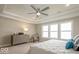 Bright and airy main bedroom featuring a tray ceiling, large window, and stylish furnishings at 9658 Farragut, Indianapolis, IN 46256