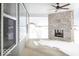 Covered porch with stone fireplace feature, ceiling fan, and outdoor view on a snowy day at 9658 Farragut, Indianapolis, IN 46256