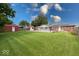This back yard is spacious, featuring a pool, a shed, and a well-maintained lawn at 1002 Payton Ave, Indianapolis, IN 46219