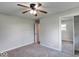 This bedroom features carpeted floors, a ceiling fan, and a closet with mirrored doors at 1002 Payton Ave, Indianapolis, IN 46219
