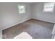 Neutral bedroom featuring two large windows and plush carpeting at 1002 Payton Ave, Indianapolis, IN 46219