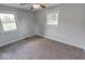 This bedroom is bright and airy, with two large windows and carpeted floors at 1002 Payton Ave, Indianapolis, IN 46219