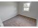 This bedroom has carpeted floors and a large window for plenty of natural light at 1002 Payton Ave, Indianapolis, IN 46219