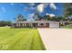 A charming single-story brick home with a well-manicured lawn and an extended driveway at 1002 Payton Ave, Indianapolis, IN 46219