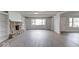 Bright living room with a stone fireplace, built-in shelving, large windows, and an open floor plan at 1002 Payton Ave, Indianapolis, IN 46219