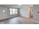 Bright living space featuring modern flooring, ample natural light, and a welcoming front door at 1002 Payton Ave, Indianapolis, IN 46219