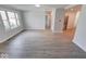 Bright living room boasts large windows and stylish gray wood flooring at 1002 Payton Ave, Indianapolis, IN 46219