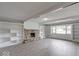 Spacious living room with stone fireplace, built-in shelving, and large window at 1002 Payton Ave, Indianapolis, IN 46219