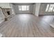 Expansive living area with a stone fireplace, built-in shelving, and modern flooring throughout at 1002 Payton Ave, Indianapolis, IN 46219