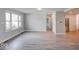 Bright living room boasts large windows and stylish gray wood flooring at 1002 Payton Ave, Indianapolis, IN 46219