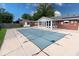 The in-ground pool is fenced and covered, with access to the sunroom and back yard at 1002 Payton Ave, Indianapolis, IN 46219