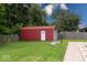 This shed is spacious, featuring a metal door, a white trim, and room for storage at 1002 Payton Ave, Indianapolis, IN 46219