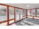 This sunroom features wood trim, tiled floors, lots of light, and access to the back yard at 1002 Payton Ave, Indianapolis, IN 46219