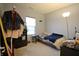 Bedroom with a garment rack, end table, and a bed covered in plush blankets at 1169 Richmond Ln, Greenwood, IN 46143
