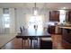 Stylish dining area with a dark wood table, providing a welcoming space adjacent to the kitchen at 1169 Richmond Ln, Greenwood, IN 46143