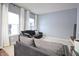 Comfortable living room with large windows offering natural light and a dark sofa with decorative pillows at 1169 Richmond Ln, Greenwood, IN 46143