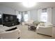 Bright living room featuring neutral walls, white sofas, modern furniture, and ample natural light from the windows at 1169 Richmond Ln, Greenwood, IN 46143