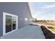 Spacious concrete patio perfect for outdoor entertaining, adjacent to vinyl siding and a well-kept lawn at 1438 Willow Tree Ln, Sheridan, IN 46069