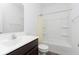 A full bathroom with a shower and tub combo, plus a single vanity with dark cabinets at 1438 Willow Tree Ln, Sheridan, IN 46069