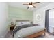 Charming bedroom with a green accent wall and a neutral decor with a ceiling fan at 1438 Willow Tree Ln, Sheridan, IN 46069