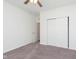 Bedroom with neutral carpet and white walls, ceiling fan, window, and closet at 1438 Willow Tree Ln, Sheridan, IN 46069