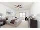 Bright bedroom with a ceiling fan, neutral color palette, and a large window for plenty of natural light at 1438 Willow Tree Ln, Sheridan, IN 46069