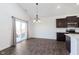 Cozy dining area with a modern chandelier, sliding glass doors, and dark wood-look floors at 1438 Willow Tree Ln, Sheridan, IN 46069