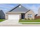 Charming single-Gathering home with brick and vinyl siding, attached garage, and well-manicured lawn at 1438 Willow Tree Ln, Sheridan, IN 46069