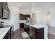 Bright kitchen with dark cabinets, stainless steel appliances, and a marble-topped island at 1438 Willow Tree Ln, Sheridan, IN 46069