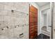 Bathroom showing a stacked storage unit with modern gray stone flooring, tiled walls and a towel rack at 1545 Temperance Ave, Indianapolis, IN 46203