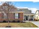 Well maintained one-story home with brick and gray siding and manicured lawn at 17330 Graley Pl, Westfield, IN 46074