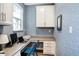 Efficient home office with built-in desk, upper cabinets, and great natural light for a productive workspace at 17330 Graley Pl, Westfield, IN 46074