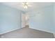 Bright bedroom features soft blue walls, carpet, and a ceiling fan at 17738 Cedarbrook Dr, Westfield, IN 46074