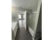 Bathroom with white door, shower with partial glass door, dark floors, and neutral walls at 1881 Harvest Meadow Dr, Greenwood, IN 46143