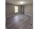 The bedroom features gray wood-look floors and natural light at 1881 Harvest Meadow Dr, Greenwood, IN 46143