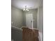 Featuring hardwood floors, neutral walls, a modern light fixture, and a view of the staircase at 1881 Harvest Meadow Dr, Greenwood, IN 46143
