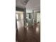 Upstairs hallway with hardwood floors leading to a bathroom with a shower and sink at 1881 Harvest Meadow Dr, Greenwood, IN 46143